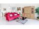 Bright living room featuring a stylish red sofa and decorative entertainment center at 1809 Forough Cir, Port Orange, FL 32128