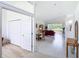 Bright living room with wood flooring and lake views, featuring a dining table and a comfortable sofa at 1809 Forough Cir, Port Orange, FL 32128
