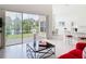 Open-concept living room featuring seamless transition to screened lanai with pond view at 1809 Forough Cir, Port Orange, FL 32128