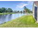Scenic view of a well maintained community pond and fountain with landscaped greenery and a white fence at 1809 Forough Cir, Port Orange, FL 32128