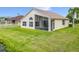 A beautiful property with a screened lanai, large windows, and a well-maintained lawn near a tranquil pond at 1809 Forough Cir, Port Orange, FL 32128