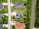 Aerial view of a home with solar panels, surrounded by a green lawn and neighborhood streets at 19 Abacus Ave, Ormond Beach, FL 32174