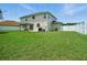 Large backyard with lush green grass, a pergola and white vinyl fence at 19 Abacus Ave, Ormond Beach, FL 32174