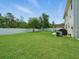 Spacious backyard featuring a well-maintained lawn, trees, and a fenced perimeter at 19 Abacus Ave, Ormond Beach, FL 32174