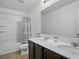 Bathroom features a shower-tub combo with sliding shower door and a double sink vanity at 19 Abacus Ave, Ormond Beach, FL 32174