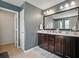 Bathroom features a double sink vanity with dark wood cabinets and a large mirror at 19 Abacus Ave, Ormond Beach, FL 32174