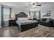This bedroom has a large bed with a plaid blanket, a sofa, and two windows at 19 Abacus Ave, Ormond Beach, FL 32174