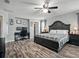 This bedroom has wood flooring, a ceiling fan, and a large bed with a plaid blanket at 19 Abacus Ave, Ormond Beach, FL 32174