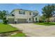Stunning two-story home with a three-car garage, solar panels, and well-manicured lawn at 19 Abacus Ave, Ormond Beach, FL 32174