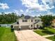 Aerial view of a beautiful home with solar panels, green lawn, and lush landscaping at 19 Abacus Ave, Ormond Beach, FL 32174