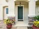 Charming front door entrance is flanked by stacked stone columns and colorful landscaping at 19 Abacus Ave, Ormond Beach, FL 32174
