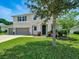 Charming two-story home boasts a well-manicured lawn and a two car garage at 19 Abacus Ave, Ormond Beach, FL 32174