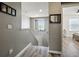 Second floor hallway leading to a bedroom, with natural light coming from a window at 19 Abacus Ave, Ormond Beach, FL 32174