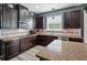 Spacious kitchen island featuring granite countertops and dark wood cabinetry, with modern appliances at 19 Abacus Ave, Ormond Beach, FL 32174