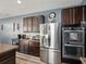 Modern kitchen featuring stainless steel appliances, granite countertops, and rich dark wood cabinetry at 19 Abacus Ave, Ormond Beach, FL 32174