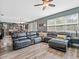 Spacious living room featuring a large sectional sofa and wood-look floors with access to the kitchen at 19 Abacus Ave, Ormond Beach, FL 32174