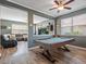 Billiard room open to the living area highlighting the plank floors and natural light at 19 Abacus Ave, Ormond Beach, FL 32174