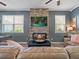 Relaxing living room features a stone fireplace, plank flooring, and a comfortable seating area at 19 Abacus Ave, Ormond Beach, FL 32174