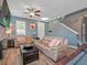 Cozy living room featuring plank flooring, a ceiling fan, and comfortable seating at 19 Abacus Ave, Ormond Beach, FL 32174