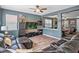 Living room with wood-look floors and entertainment center flows into Gathering room and pool table area at 19 Abacus Ave, Ormond Beach, FL 32174