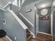 Staircase featuring wood steps, gray walls, and a classic clock on the wall at 19 Abacus Ave, Ormond Beach, FL 32174