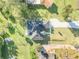 Aerial view of home showcasing the roof, driveway, and spacious landscaped yard at 1929 Pioneer Trl, New Smyrna Beach, FL 32168