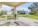 Relaxing back patio with BBQ grill overlooking the expansive fenced backyard at 1929 Pioneer Trl, New Smyrna Beach, FL 32168