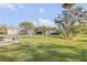 Spacious backyard with lush green lawn, patio area, and mature landscaping at 1929 Pioneer Trl, New Smyrna Beach, FL 32168