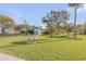 Well-maintained backyard with a storage shed and mature trees at 1929 Pioneer Trl, New Smyrna Beach, FL 32168