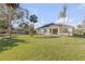 Expansive backyard with mature landscaping, patio, and room for outdoor activities at 1929 Pioneer Trl, New Smyrna Beach, FL 32168