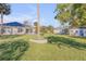 Large backyard featuring lush greenery, mature landscaping, and patio at 1929 Pioneer Trl, New Smyrna Beach, FL 32168