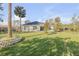 Spacious backyard with mature trees, lush lawn, and storage shed at 1929 Pioneer Trl, New Smyrna Beach, FL 32168