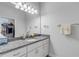 Bathroom with granite countertop, modern light fixtures and ample storage space at 1929 Pioneer Trl, New Smyrna Beach, FL 32168