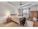 The main bedroom features a ceiling fan and bedside lamps and an exterior window at 1929 Pioneer Trl, New Smyrna Beach, FL 32168