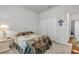 Bedroom boasts a patterned bedspread, carpeted floors, closet and lots of natural light at 1929 Pioneer Trl, New Smyrna Beach, FL 32168
