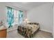 Cozy bedroom with a patterned bedspread, curtains, and a window for natural light at 1929 Pioneer Trl, New Smyrna Beach, FL 32168