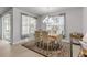 Bright dining room features a decorative chandelier, large windows and a patterned rug at 1929 Pioneer Trl, New Smyrna Beach, FL 32168