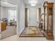 Bright foyer featuring tile floors, a decorative rug, and a glimpse into the adjacent living space at 1929 Pioneer Trl, New Smyrna Beach, FL 32168