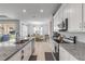 Kitchen featuring granite countertops, stainless appliances, and open dining area at 1929 Pioneer Trl, New Smyrna Beach, FL 32168