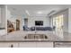 Modern kitchen features a granite countertop island with a stainless steel sink and views to the living area at 1929 Pioneer Trl, New Smyrna Beach, FL 32168