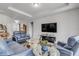 Bright living room featuring comfortable seating and a large flat-screen television at 1929 Pioneer Trl, New Smyrna Beach, FL 32168