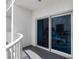 A condo balcony with railing and sliding glass door with a view of a nearby tower at 2 Oceans West Blvd # 608, Daytona Beach Shores, FL 32118