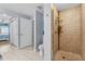 Walk-in shower featuring tile surround and upgraded shower head in primary bathroom at 2 Oceans West Blvd # 608, Daytona Beach Shores, FL 32118