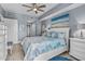 Beautifully decorated bedroom with an ocean-themed decor, ceiling fan and comfy bedding at 2 Oceans West Blvd # 608, Daytona Beach Shores, FL 32118