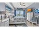 This bedroom features soft lighting, a dresser, and sliding glass doors to a balcony at 2 Oceans West Blvd # 608, Daytona Beach Shores, FL 32118