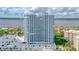Beautiful condominium building with a parking area, landscaping, and waterfront views at 2 Oceans West Blvd # 608, Daytona Beach Shores, FL 32118