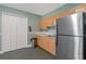 Functional kitchen area featuring light wood cabinets and a stainless steel refrigerator at 2 Oceans West Blvd # 608, Daytona Beach Shores, FL 32118