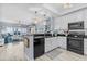 Kitchen flowing into living room with updated appliances and breakfast bar at 2 Oceans West Blvd # 608, Daytona Beach Shores, FL 32118