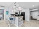 Kitchen with breakfast bar featuring black appliances, white cabinetry and natural light at 2 Oceans West Blvd # 608, Daytona Beach Shores, FL 32118