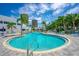 Inviting outdoor pool area with clear blue water, surrounded by palm trees and lounge chairs at 2 Oceans West Blvd # 608, Daytona Beach Shores, FL 32118